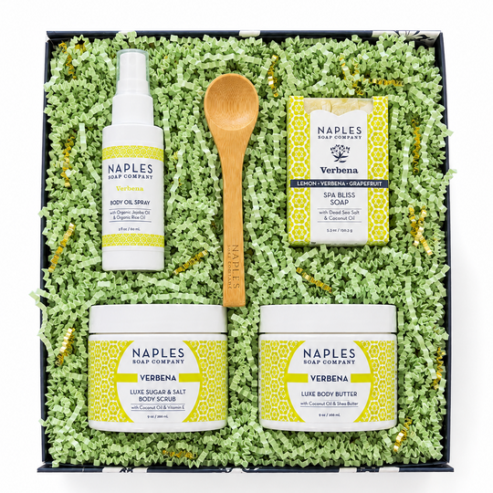Naples Soap Company Verbena self-care gift set in a blue gift box filled with green shredded paper. 